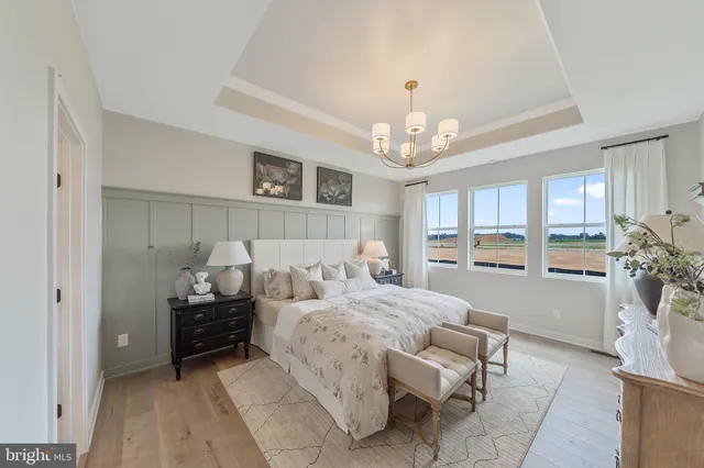 a bedroom with furniture and a chandelier