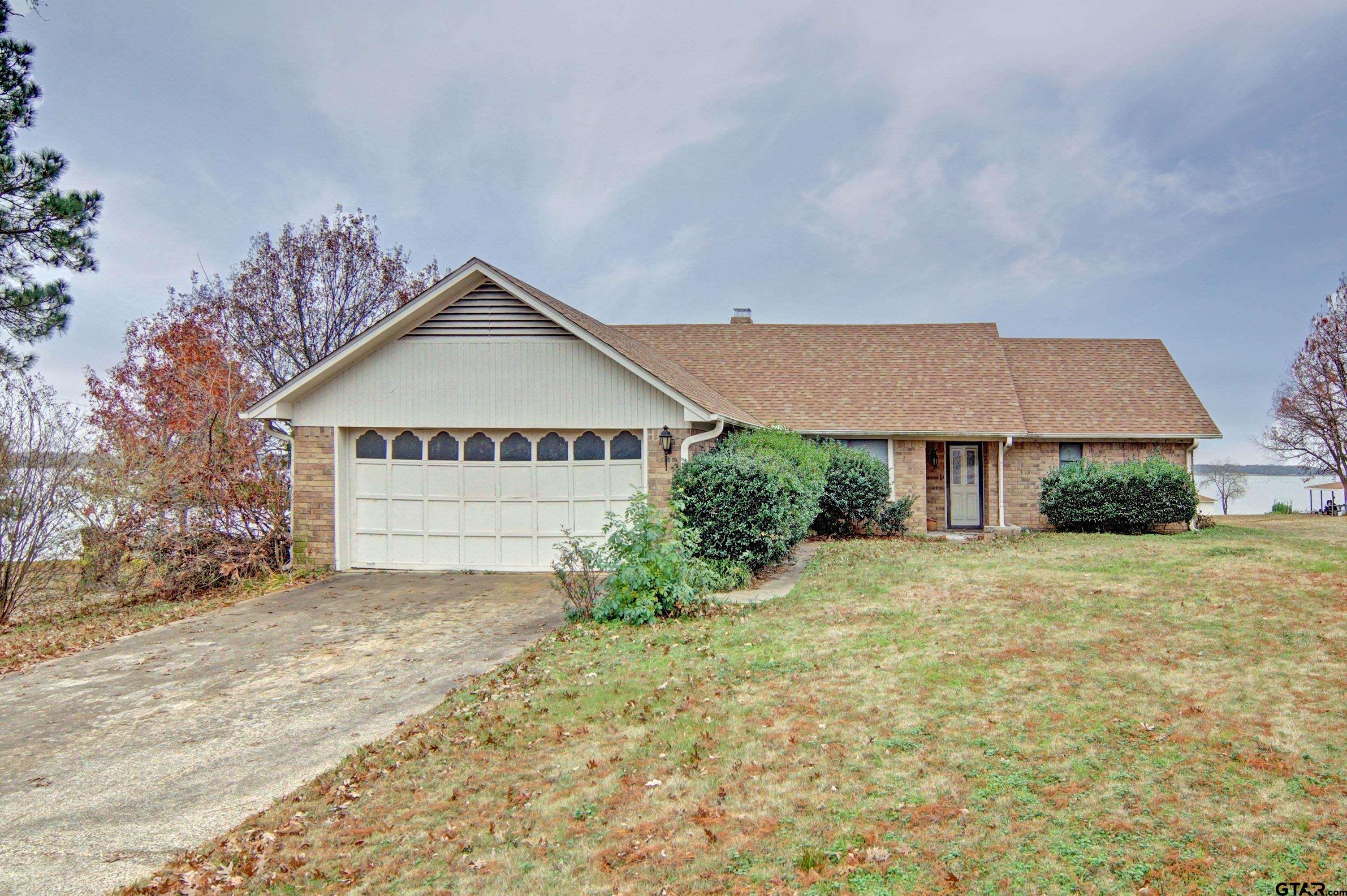 a view of a house with a yard and garage