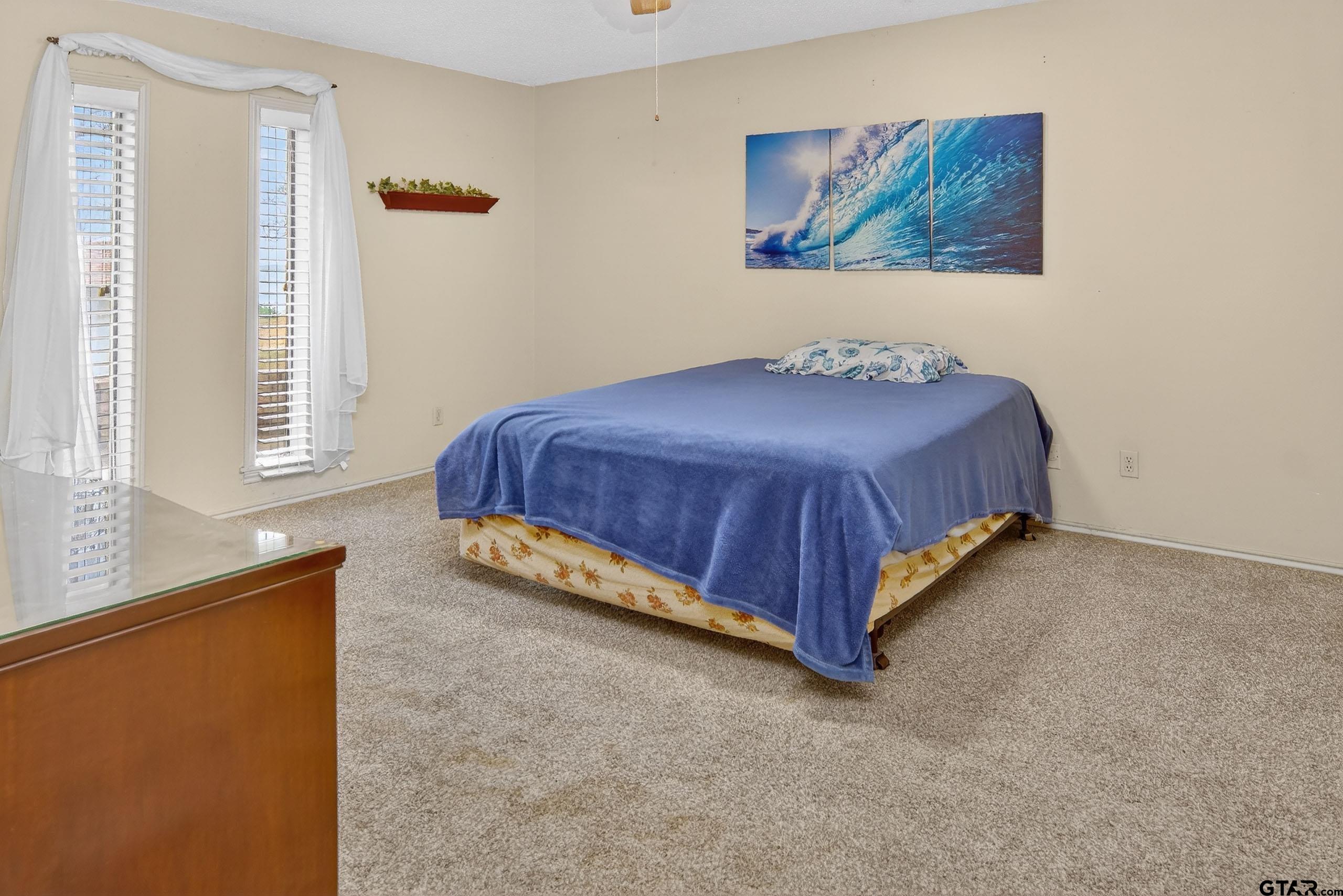 520 County Road 3445 Emory, TX 75440 - Photo 18 of 31 a spacious bedroom with a bed and a window