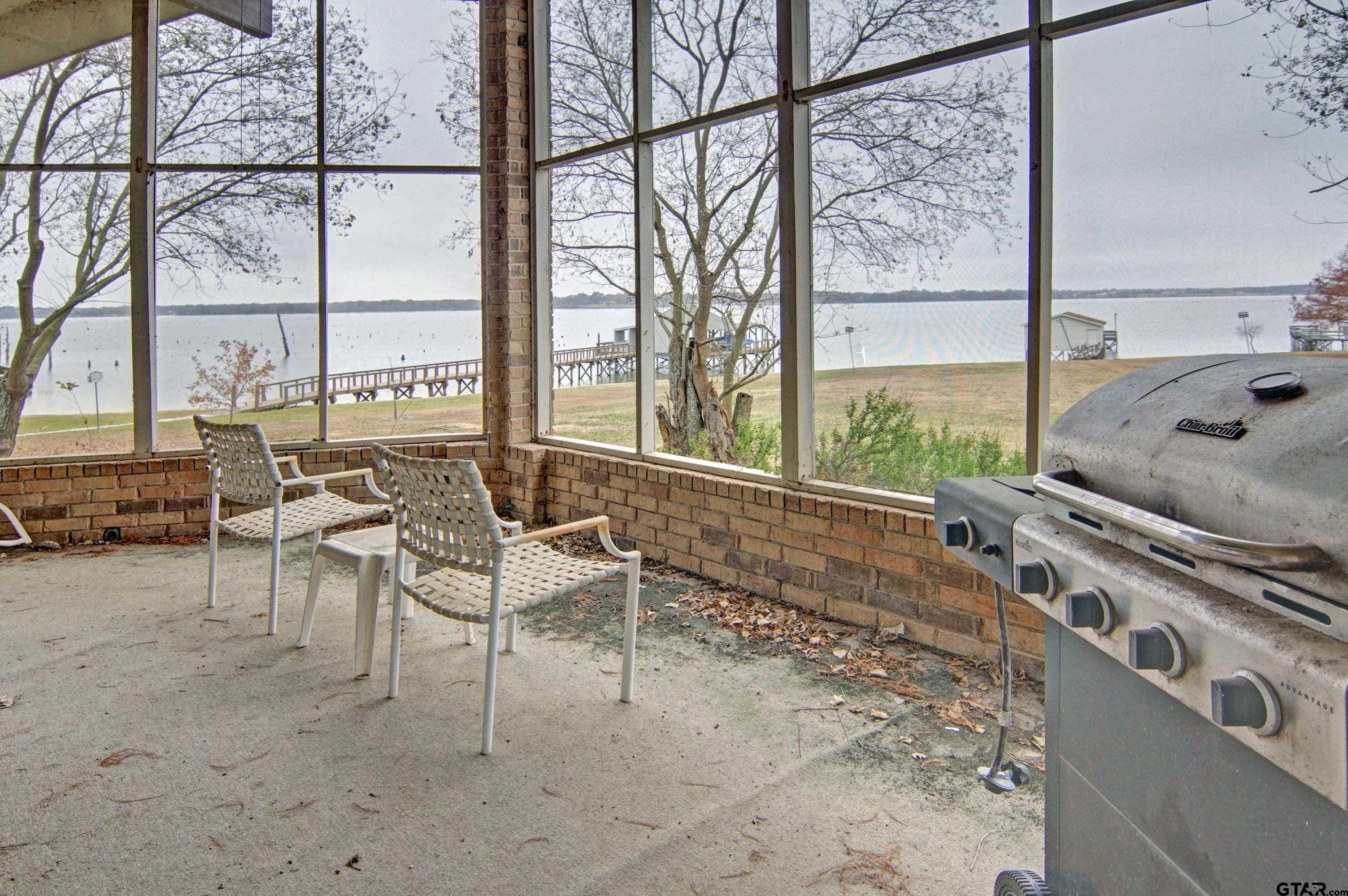 520 County Road 3445 Emory, TX 75440 - Photo 29 of 31 a living room with furniture and a floor to ceiling window