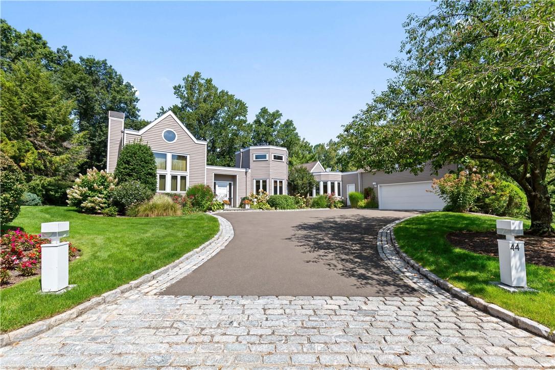 44 The Crossing Purchase, NY 10577 - Photo 1 of 1 a front view of a house with a yard and trees