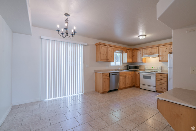 1735 West 540 North, Unit 1805 St. George, UT 84770 - Photo 17 of 64 Kitchen featuring light wood cabinetry, light-toned countertops, and a white appliance package
