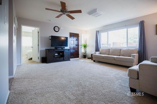 122 South Valley Street Ridgecrest, CA 93555 - Photo 5 of 26 a living room with furniture and a flat screen tv
