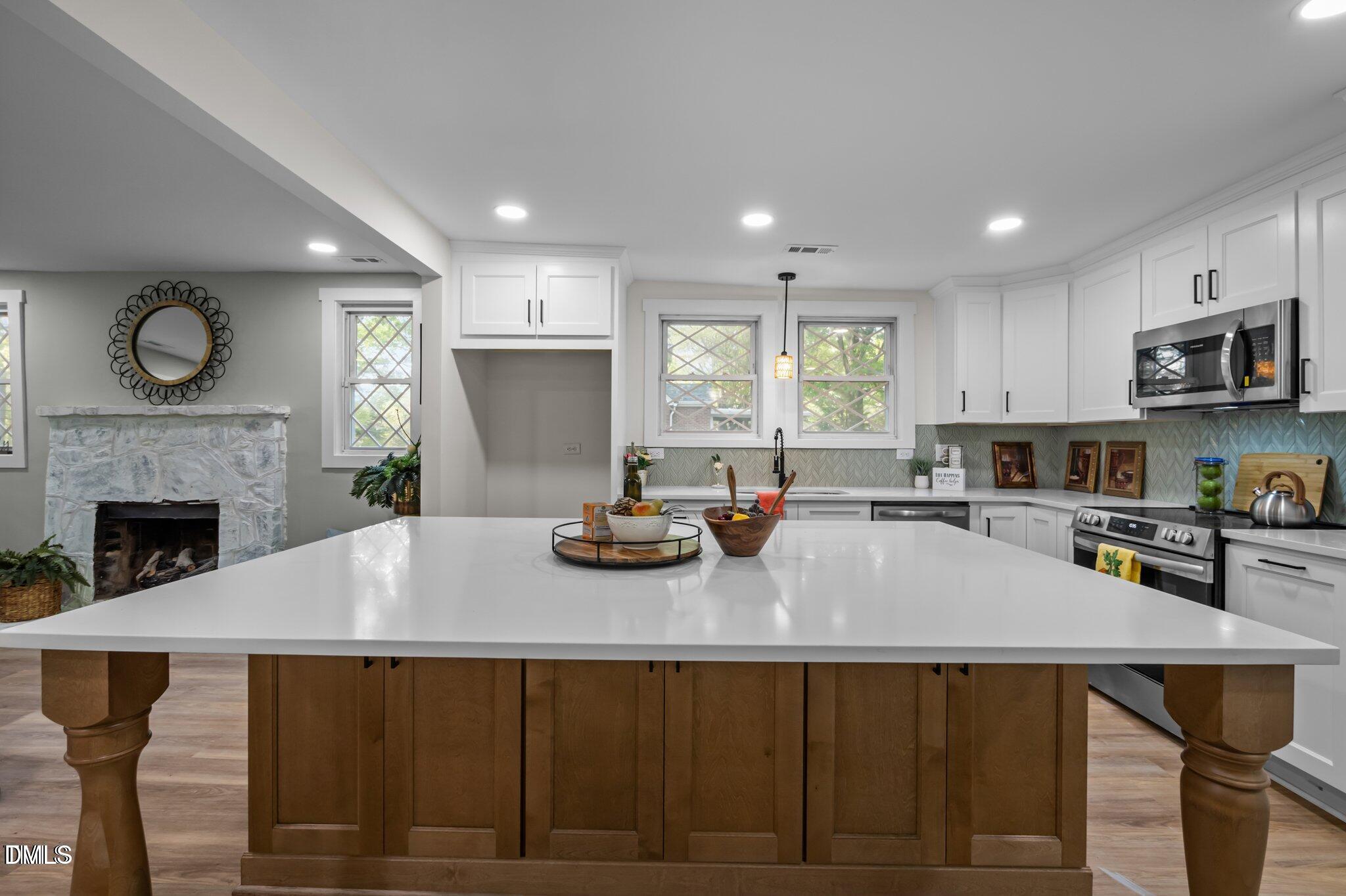 3014 Hope Valley Road Durham, NC 27707 - Photo 7 of 15 a kitchen with a table chairs sink and cabinets