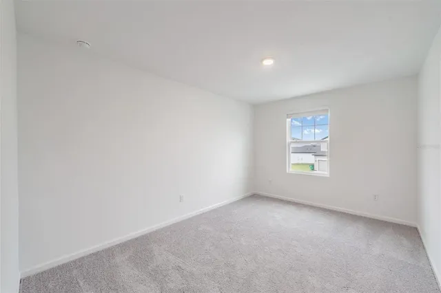 an aerial view of a house with big yard and large tree