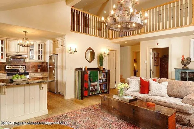 a living room with lots of furniture and a chandelier