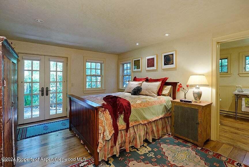 373 Sopris Creek Road, Unit 3 Basalt, CO 81621 - Photo 6 of 11 a bedroom with a bed and wooden floor