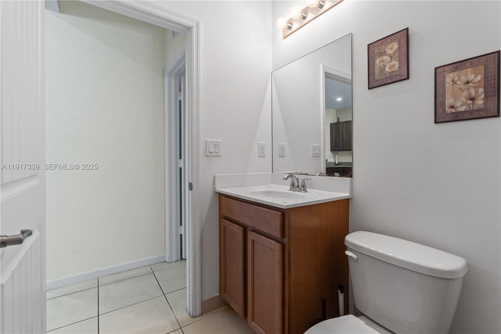 11121 Southwest 225th Terrace Miami, FL 33170 - Photo 13 of 41 a bathroom with a sink toilet and vanity