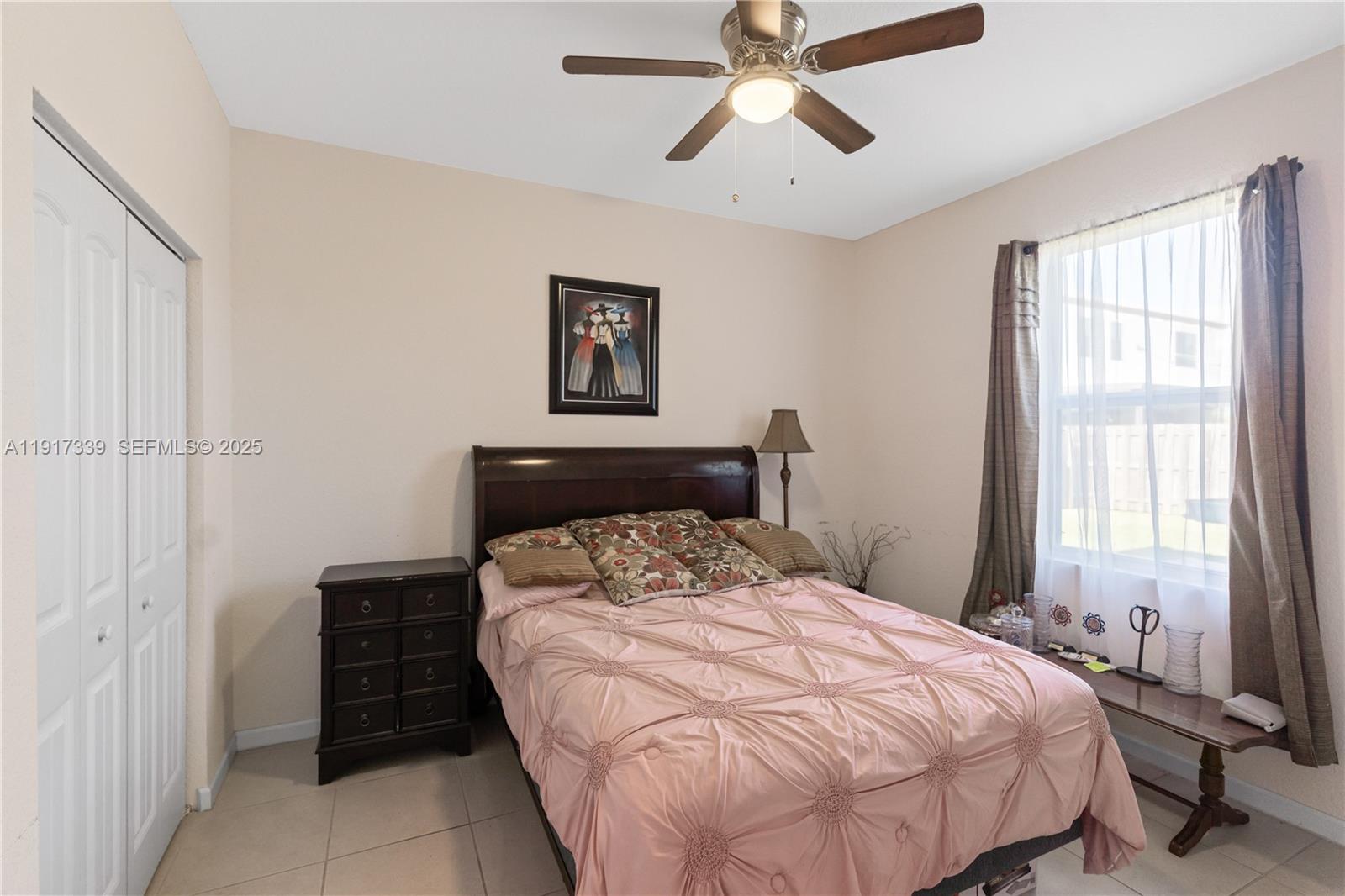 11121 Southwest 225th Terrace Miami, FL 33170 - Photo 14 of 41 a bedroom with a bed and a chandelier