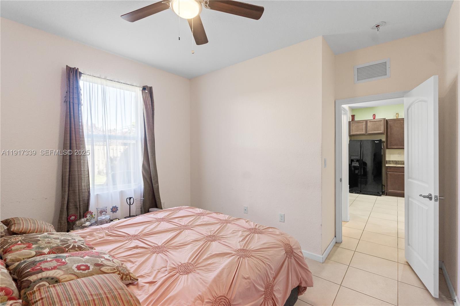 11121 Southwest 225th Terrace Miami, FL 33170 - Photo 15 of 41 a bedroom with a bed and a chandelier
