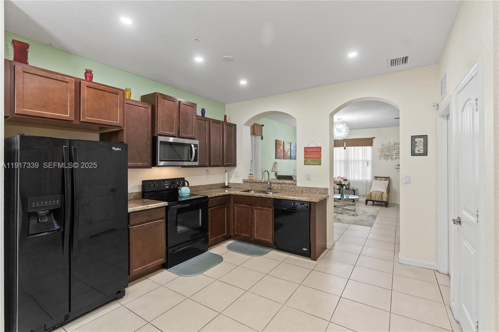 11121 Southwest 225th Terrace Miami, FL 33170 - Photo 17 of 41 a kitchen with stainless steel appliances granite countertop a refrigerator and a sink