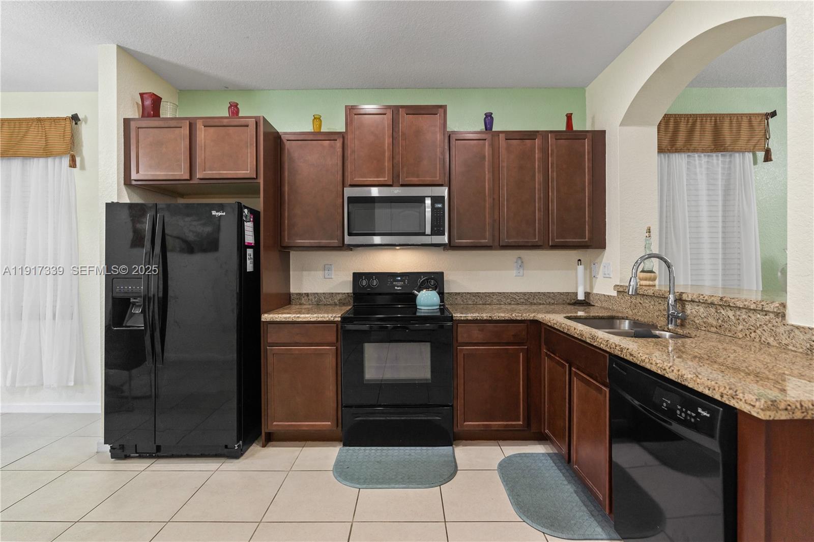 11121 Southwest 225th Terrace Miami, FL 33170 - Photo 18 of 41 a kitchen with stainless steel appliances granite countertop a refrigerator and a sink