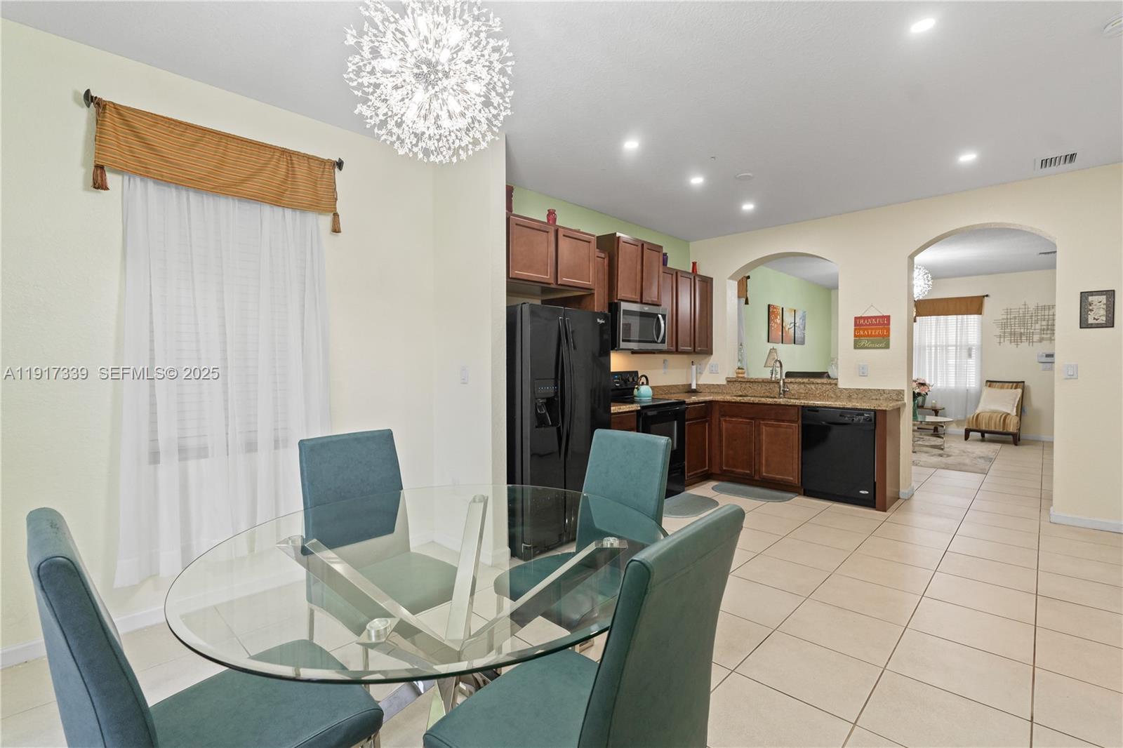 11121 Southwest 225th Terrace Miami, FL 33170 - Photo 20 of 41 a living room with kitchen view and a kitchen view