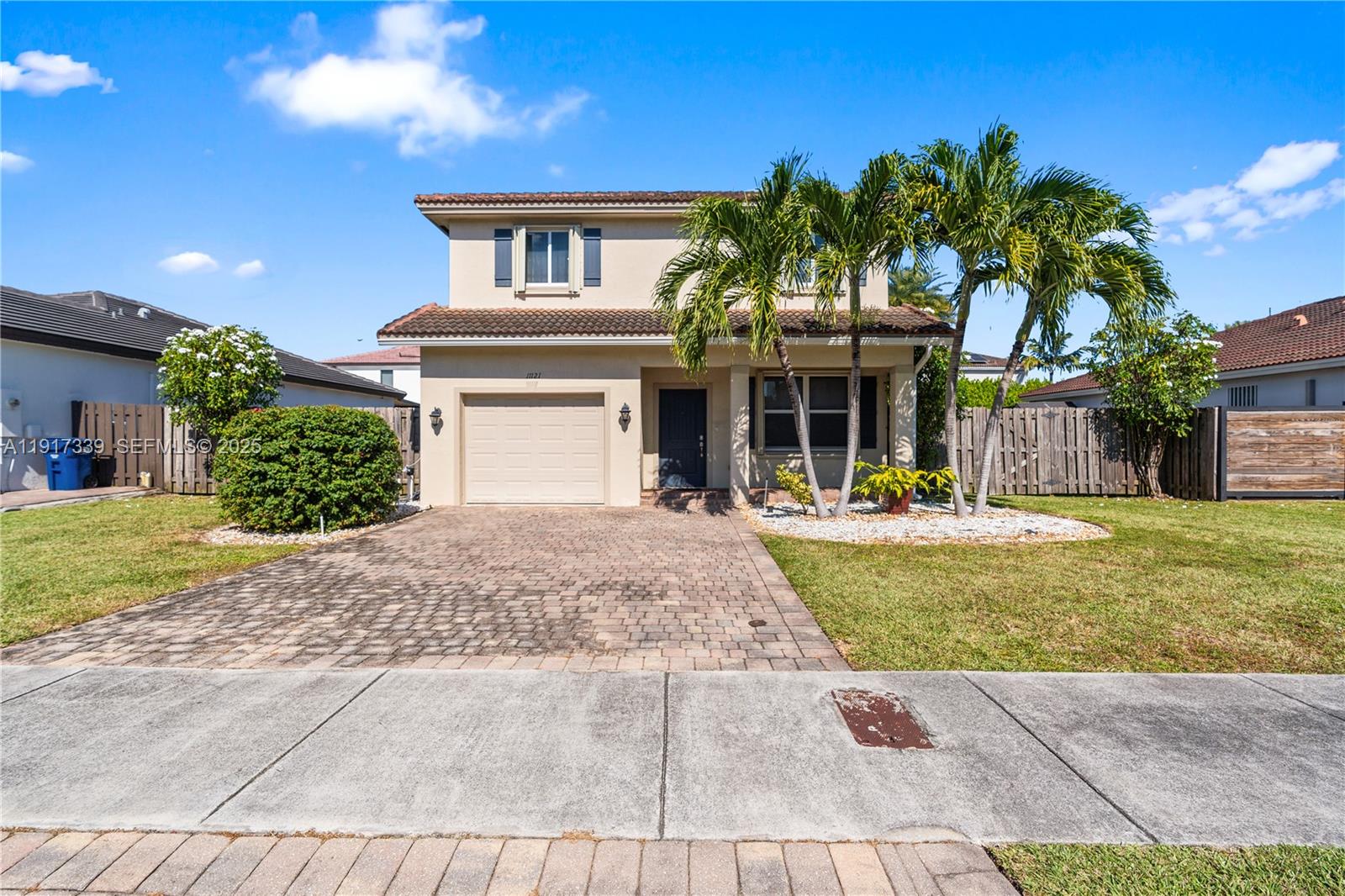 11121 Southwest 225th Terrace Miami, FL 33170 - Photo 2 of 41 a front view of a house with garden