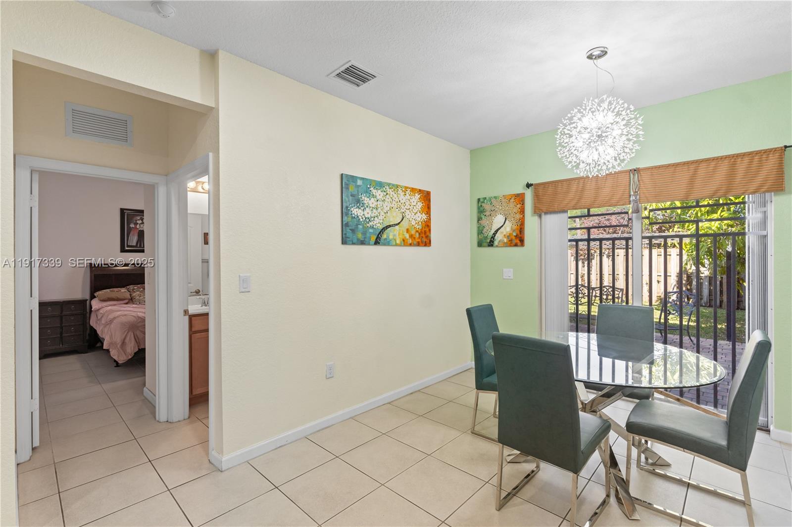 11121 Southwest 225th Terrace Miami, FL 33170 - Photo 21 of 41 a view of a dining room with furniture chandelier and a chandelier