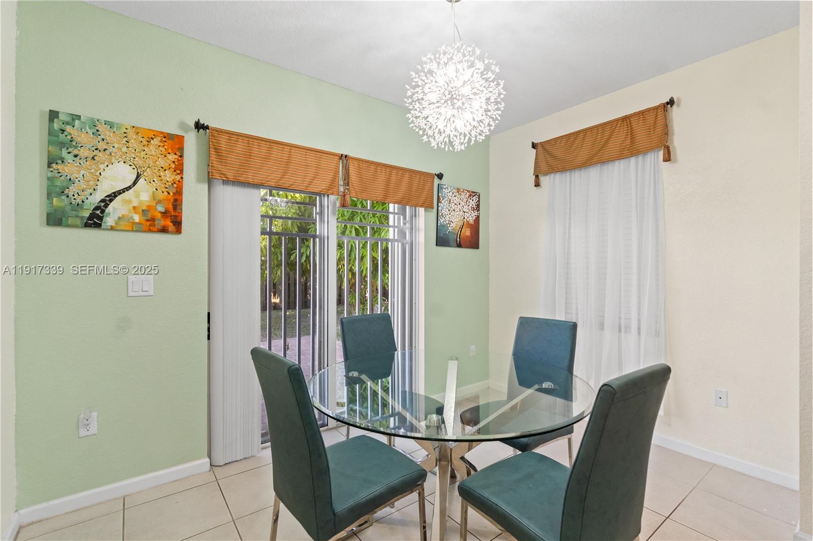 11121 Southwest 225th Terrace Miami, FL 33170 - Photo 22 of 41 a view of a dining room with furniture and chandelier