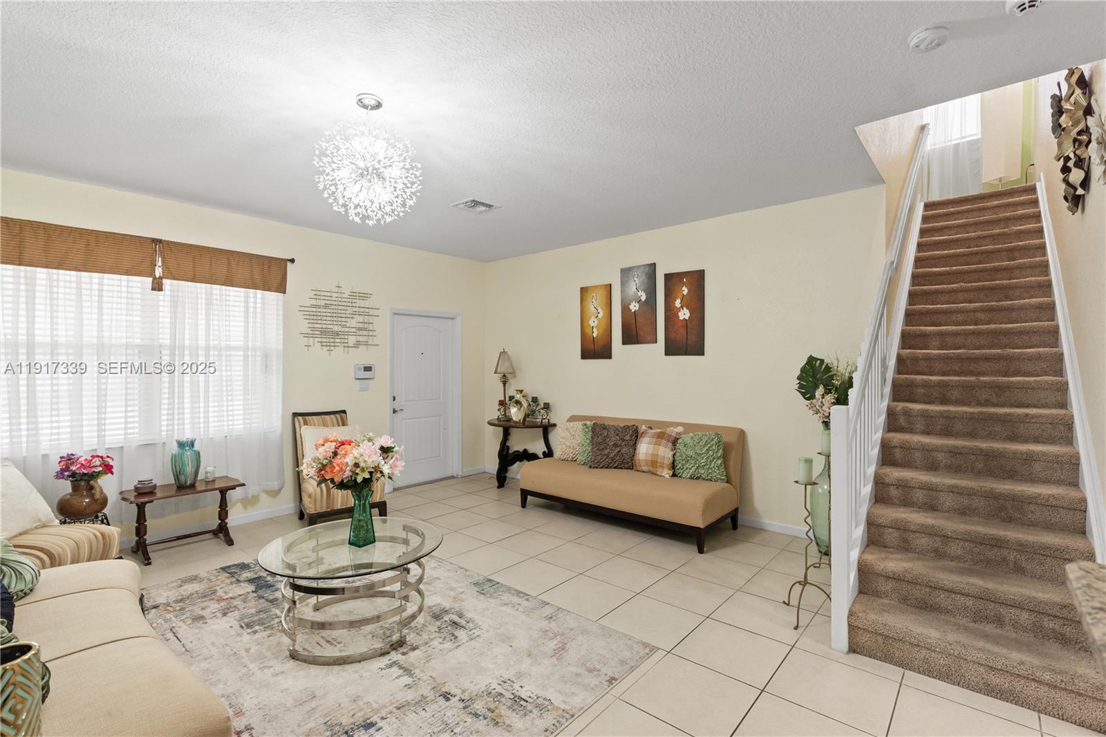 11121 Southwest 225th Terrace Miami, FL 33170 - Photo 27 of 41 a living room with furniture and flowers