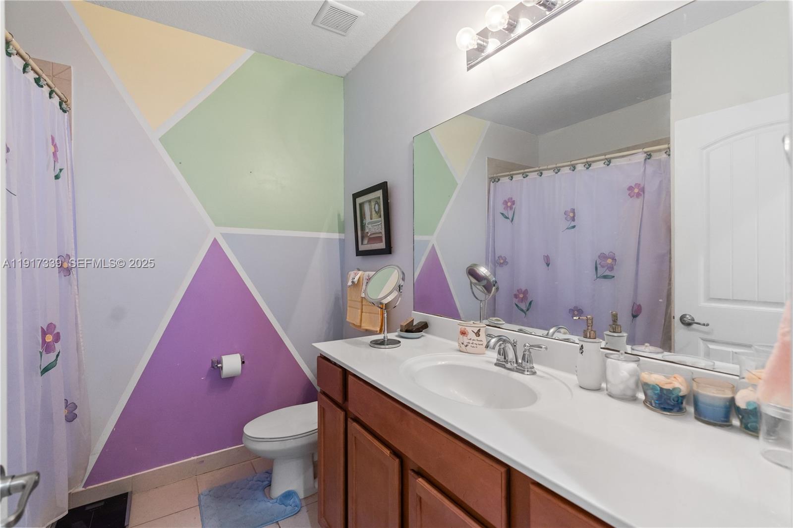 11121 Southwest 225th Terrace Miami, FL 33170 - Photo 35 of 41 a bathroom with a sink a toilet a mirror a vanity and shower