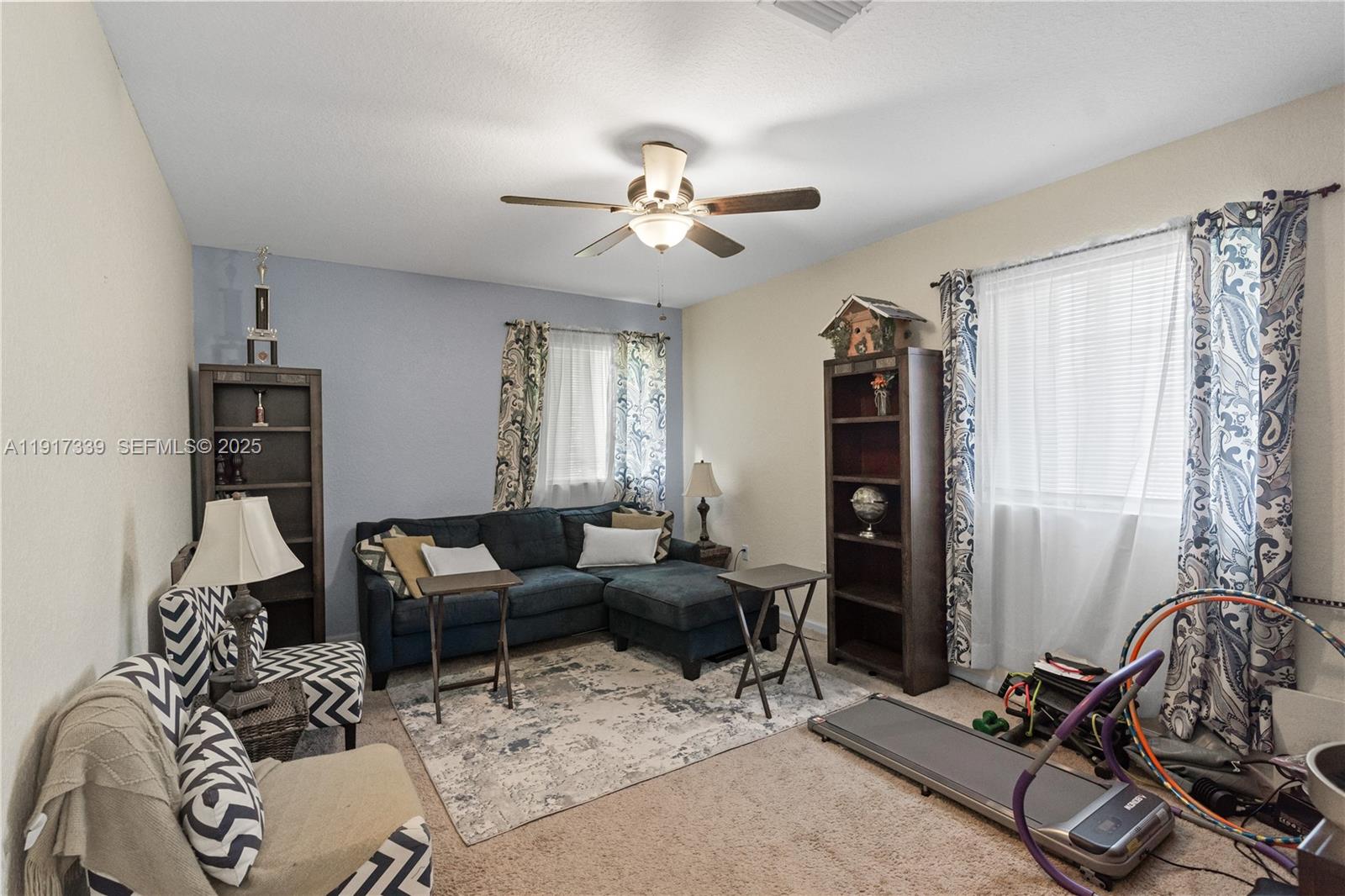 11121 Southwest 225th Terrace Miami, FL 33170 - Photo 36 of 41 a living room with furniture a chandelier fan and a window