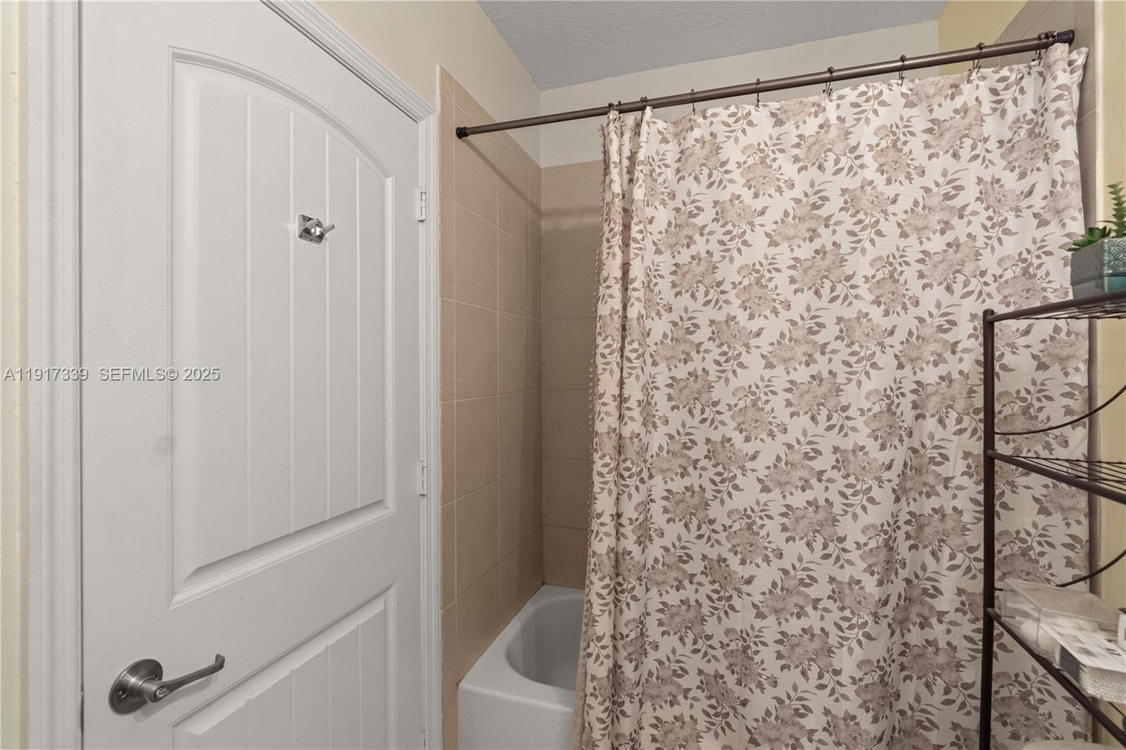 11121 Southwest 225th Terrace Miami, FL 33170 - Photo 40 of 41 a bathroom with a shower curtain