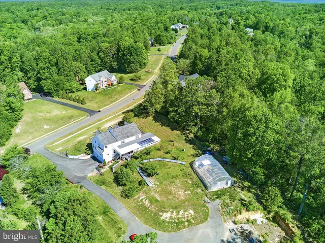 an empty room with windows and fireplace