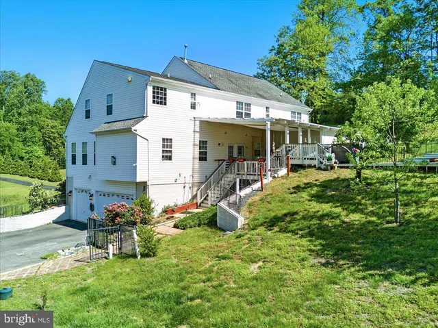 a bathroom with a bathtub shower sink vanity mirror and toilet