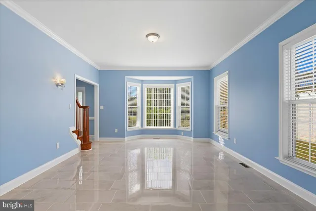 a view of staircase with railing and white walls