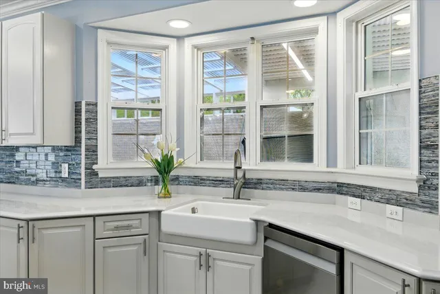 a spacious bathroom with a tub shower and a sink