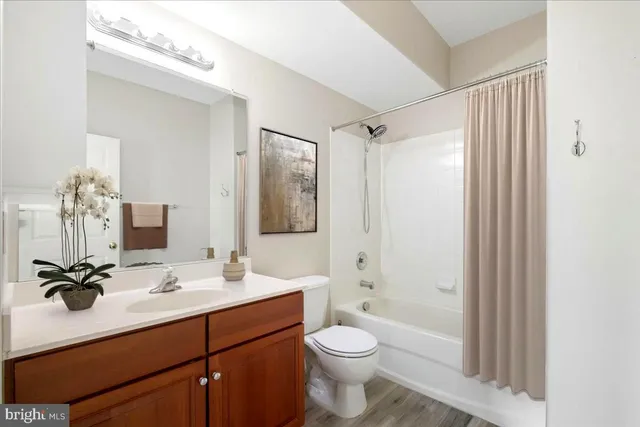 a bathroom with a sink toilet tub and shower