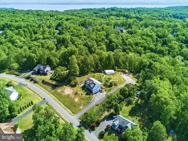 a front view of a house with a yard and potted plants