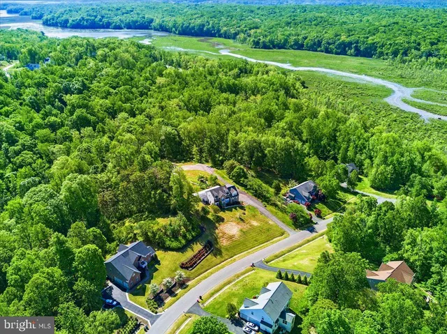 an aerial view of a house with a yard basket ball court and outdoor seating