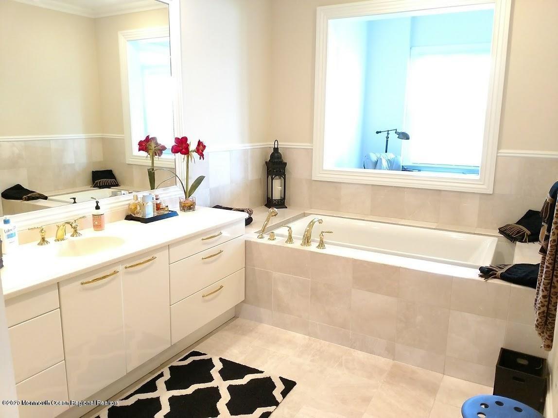 321 Oval Road Manasquan, NJ 08736 - Photo 12 of 23 a bathroom with a sink and a bathtub