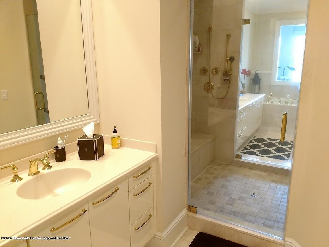 321 Oval Road Manasquan, NJ 08736 - Photo 13 of 23 a bathroom with a sink and a mirror
