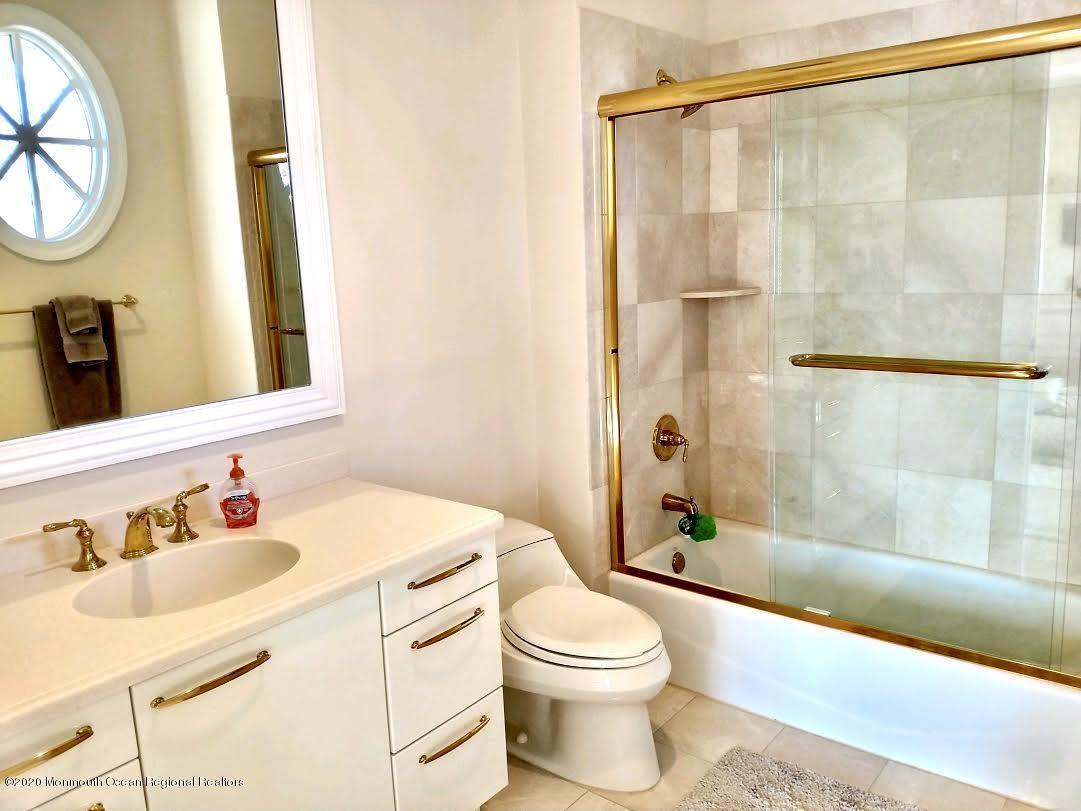 321 Oval Road Manasquan, NJ 08736 - Photo 14 of 23 a bathroom with a sink a toilet and a mirror