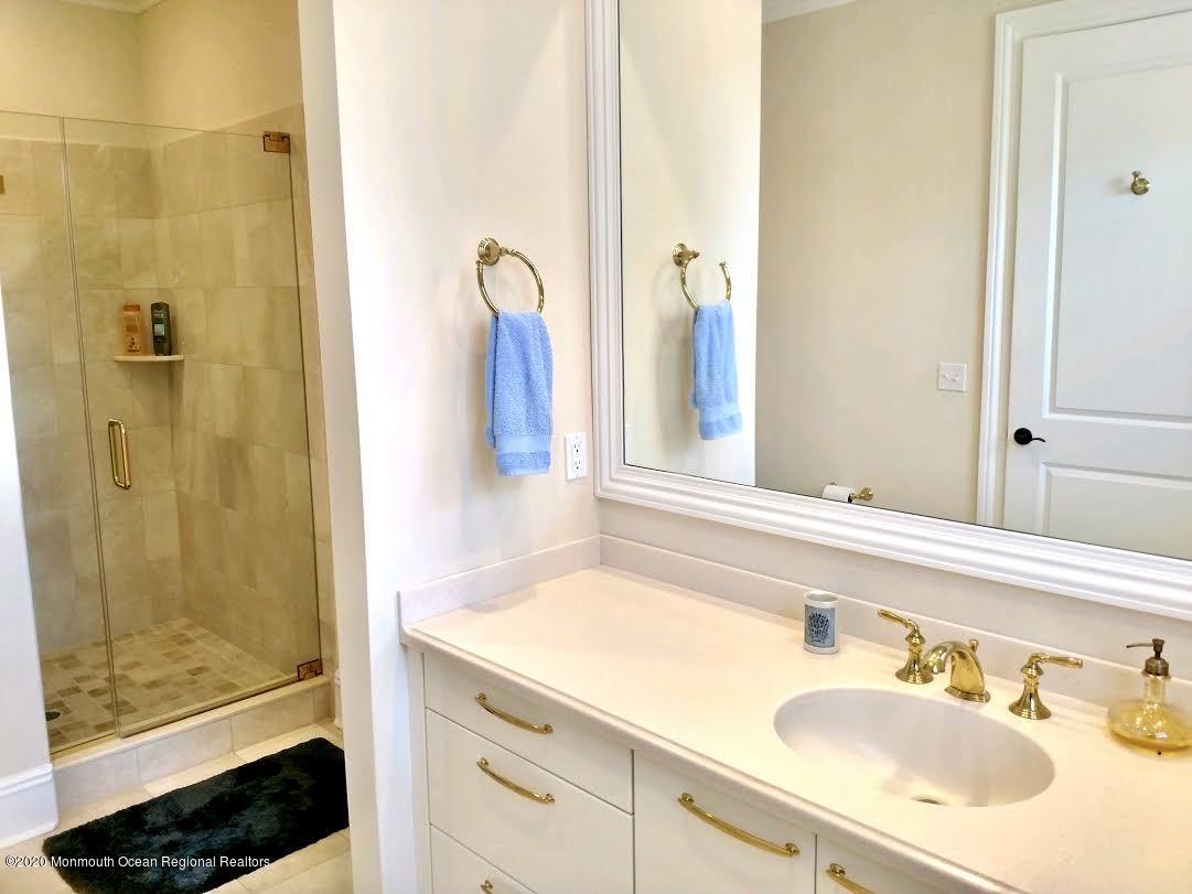 321 Oval Road Manasquan, NJ 08736 - Photo 15 of 23 a bathroom with a sink and a mirror