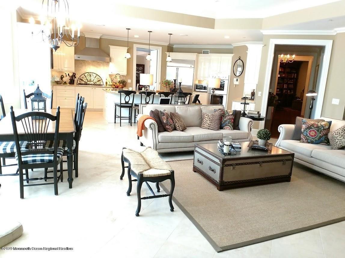 321 Oval Road Manasquan, NJ 08736 - Photo 3 of 23 a living room with furniture wooden floor dining table and a chandelier