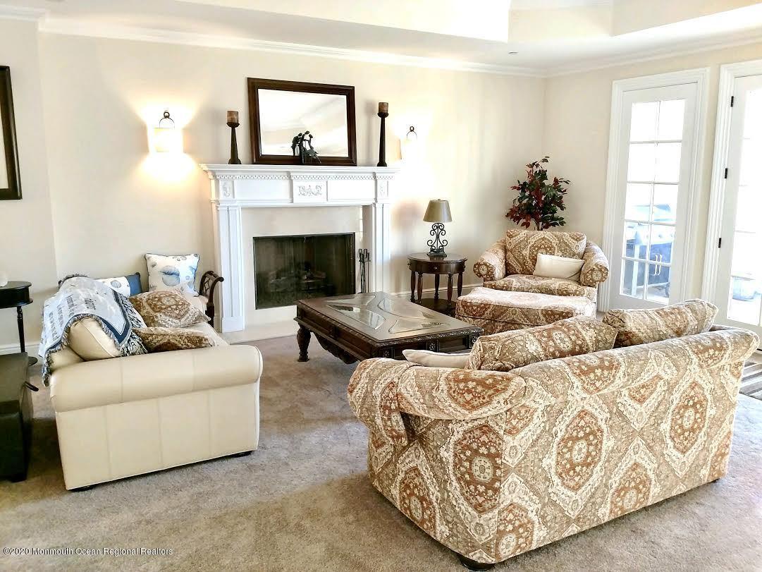 321 Oval Road Manasquan, NJ 08736 - Photo 5 of 23 a living room with furniture and a fireplace