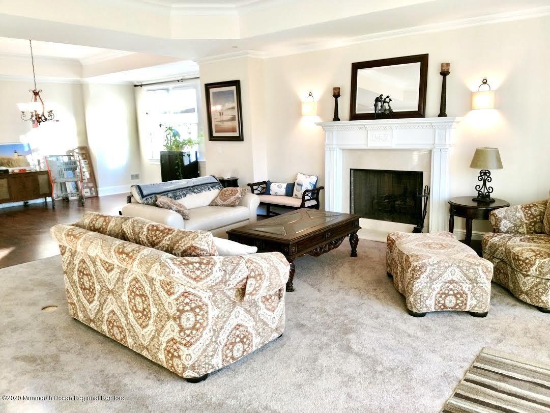 321 Oval Road Manasquan, NJ 08736 - Photo 6 of 23 a living room with furniture and a fireplace