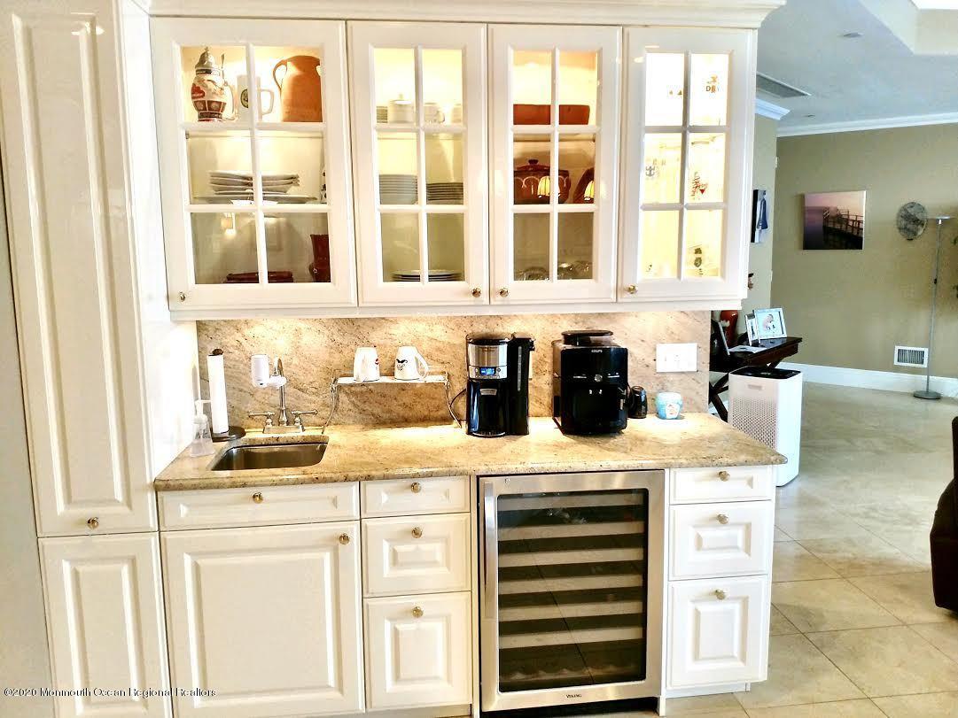 321 Oval Road Manasquan, NJ 08736 - Photo 8 of 23 a kitchen with a sink stove and cabinets