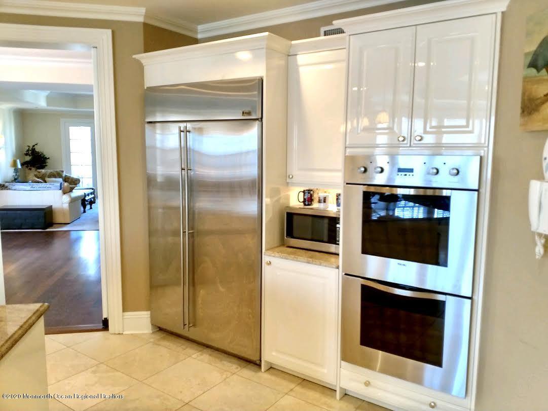 321 Oval Road Manasquan, NJ 08736 - Photo 9 of 23 a kitchen with stainless steel appliances a stove a microwave and a counter top space