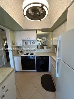 a kitchen with a stove and a refrigerator