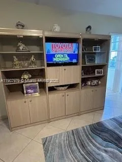 a bathroom with a sink a toilet a mirror and shower