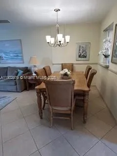 a hallway with wooden floor stairs and furniture