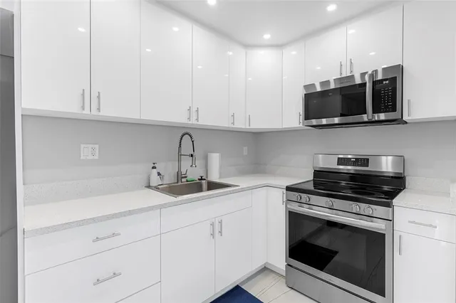 a kitchen with appliances cabinets and a sink