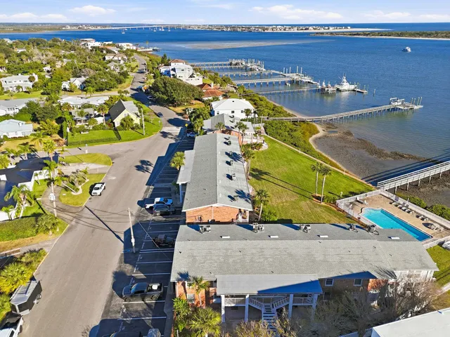 an aerial view of a houses with a swimming pool