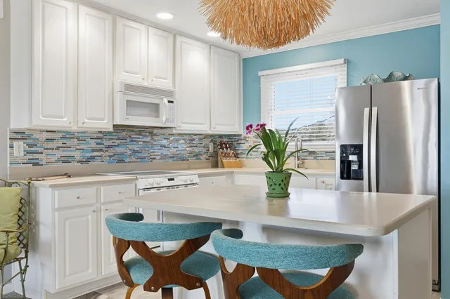 a kitchen with stainless steel appliances granite countertop a refrigerator sink and cabinets