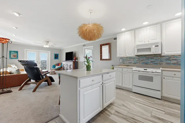 a kitchen with stainless steel appliances granite countertop white cabinets sink and dishwasher with wooden floor