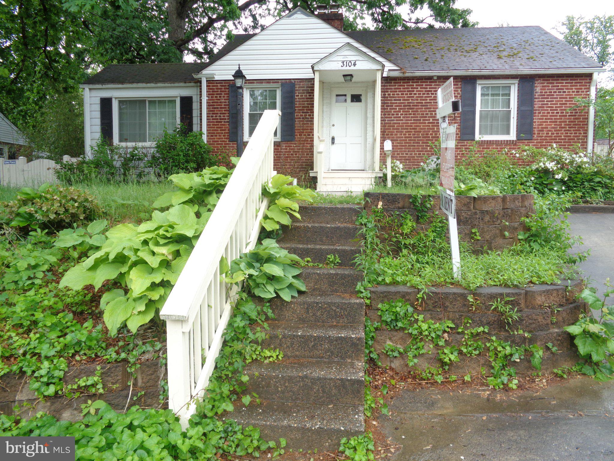 3104 Parker Avenue Silver Spring, MD 20902 - Photo 18 of 32 a front view of a house with a yard and potted plants