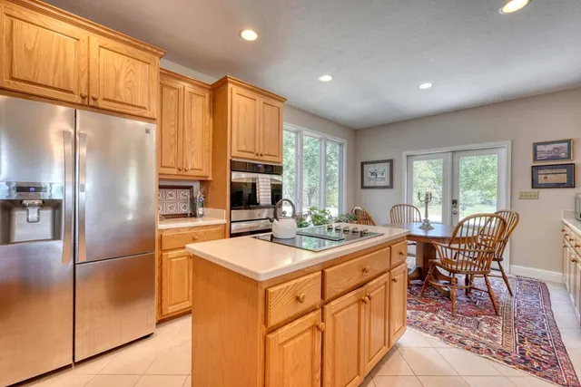 a spacious bathroom with a double vanity sink mirror and bathtub