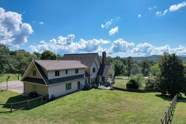 a view of a balcony with chairs and wooden floor